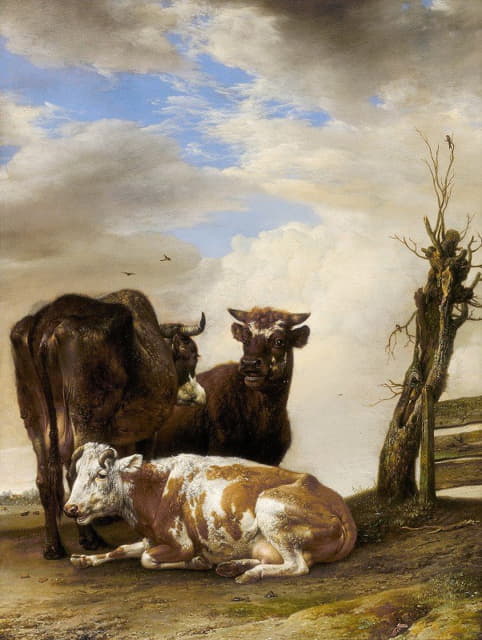 草地围栏边的两头母牛和一头小牛