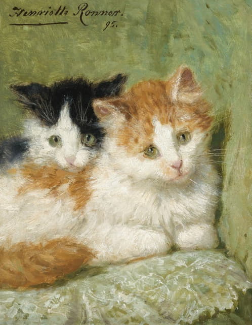 两只小猫坐在垫子上
