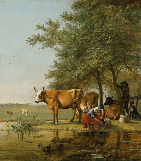 牛群和一名妇女在溪边清理水桶的景色