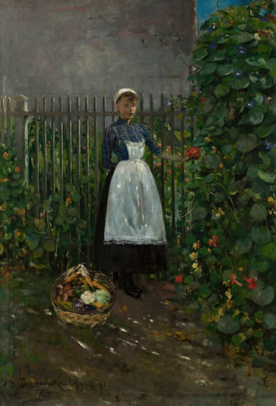 花园里拿着一篮子蔬菜的女孩