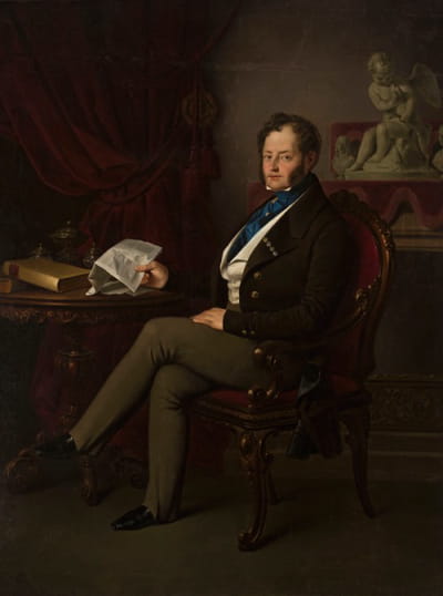 瓦迪斯瓦夫·布拉尼基的肖像，手里拿着一封信坐在那里
