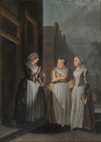 在荷兰的一个城市里，三个女人晚上聊天，一个拿着蜡烛