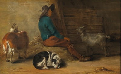 一个农民和附近的狗和山羊一起休息